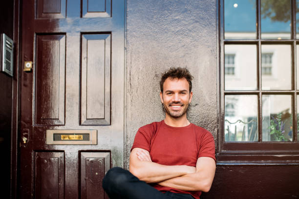 istock Man sitting in a bench on a beautiful maroon background 1098407822