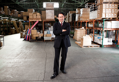 japan businessman is posing in the warehouse.