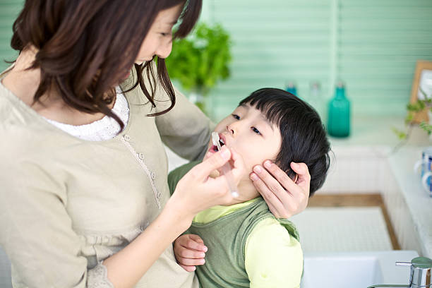Japanese Mother and Son Brushing Teeth stock photo