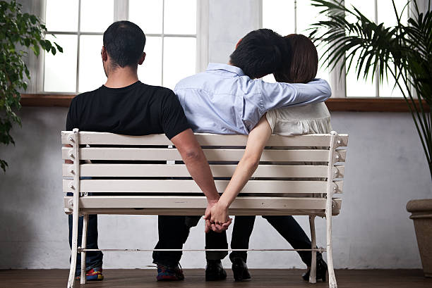 Cheating Young woman and man holding their hands behind the seat cheating lovers stock pictures, royalty-free photos & images