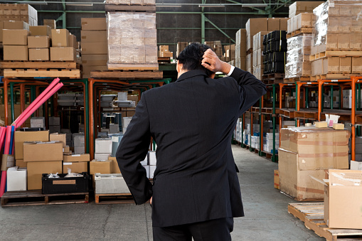japan businessman is posing in the warehouse.
