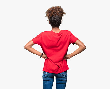 Beautiful young african american woman over isolated background standing backwards looking away with arms on body
