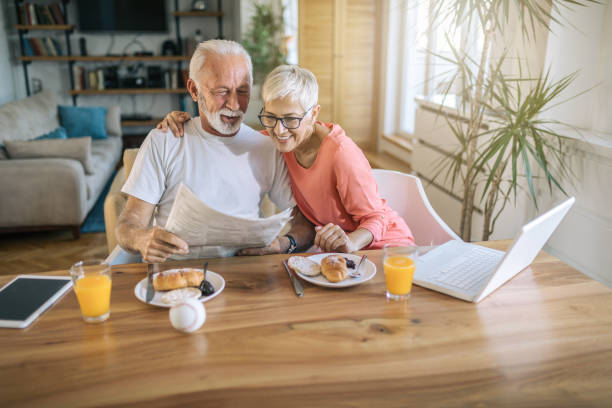 istock Modern senior coupe spending the morning together eating breakfast and reading 1098417966