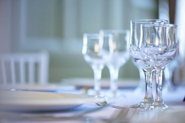 istock Clean table setting for fine dining with focus on two crystal glasses for water and wine 1098418062