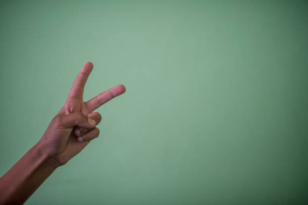 istock hand holding up peace sign 1098419098