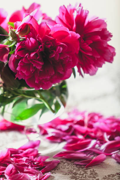 istock red peonies in glass vase stand on table 1098420958