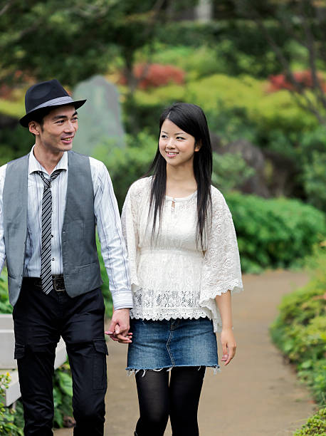 istock Young Couple Walking through the Park 109842487