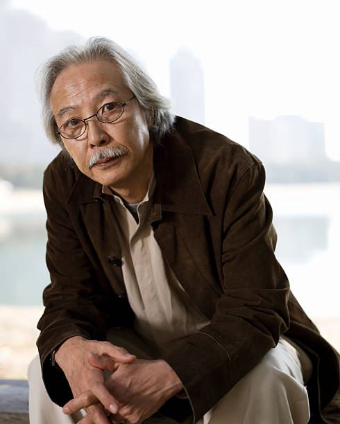 istock Elderly Asian Man Sitting on a Bench 109842499