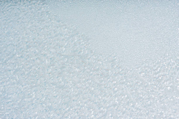 Winter background with gleaming ice. Frozen water texture. Copy space