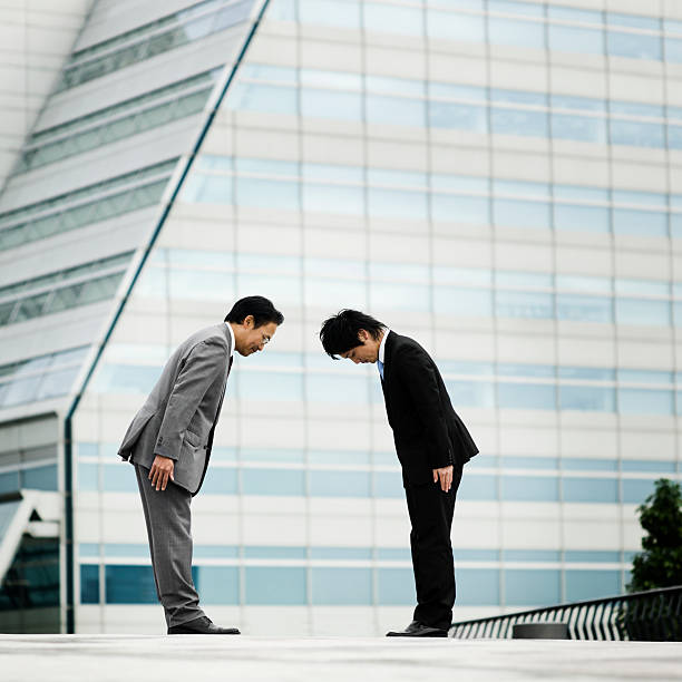 istock Two Asian Businessmen Bowing 109842525