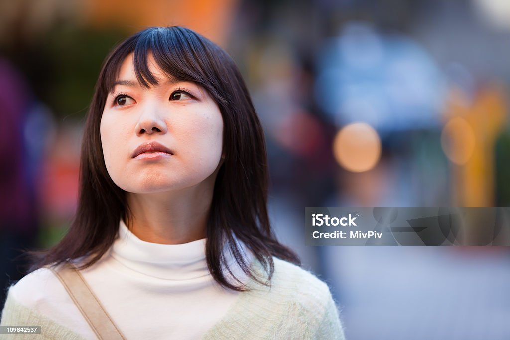 Lonely Outdoor portrait of a sad but beautiful looking young Asian woman Depression - Sadness Stock Photo