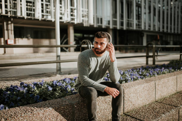 istock Young man listening with his headphones 1098426188