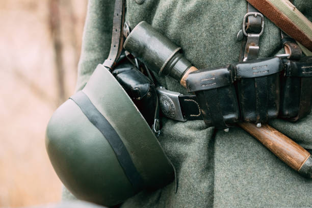 German helmet on the belt of a soldier of the Second World War Part of the German uniforms of the Second World War helmet and a grenade on the belt of a soldier battle reenactment stock pictures, royalty-free photos & images