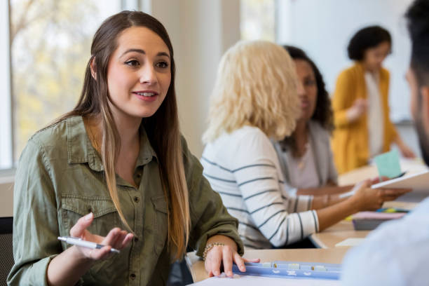istock Confident female creative professional meets talking with colleague 1098428290