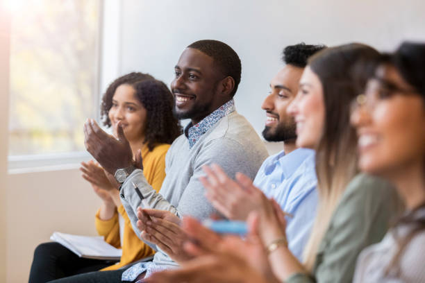 istock Diverse group of people applaud during seminar 1098428346