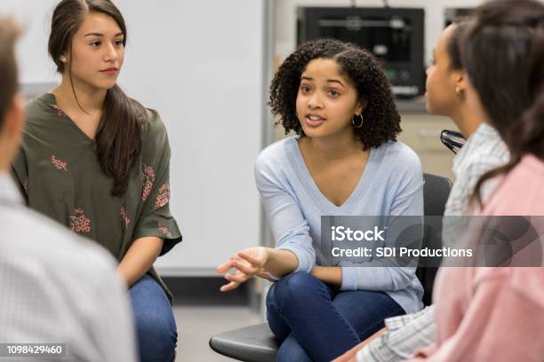 Teenage Girl Talks During Support Group Meeting Stock Photo - Download Image Now - Teenager, Discussion, Adolescence