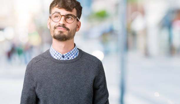 istock Young handsome smart man wearing glasses over isolated background smiling looking side and staring away thinking. 1098433782