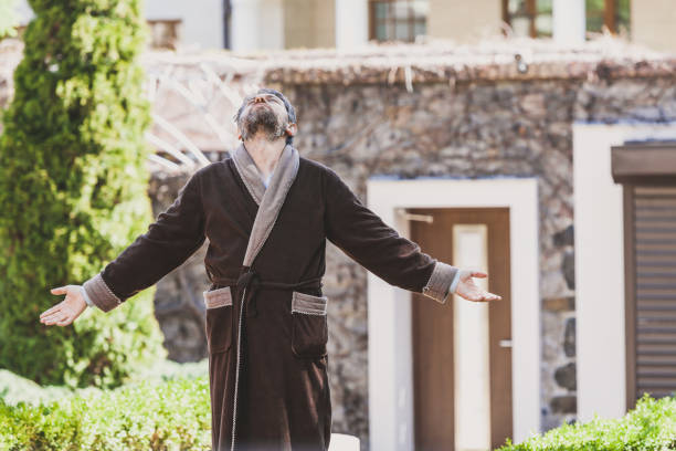 istock man in robe is standing on summer morning 1098436186