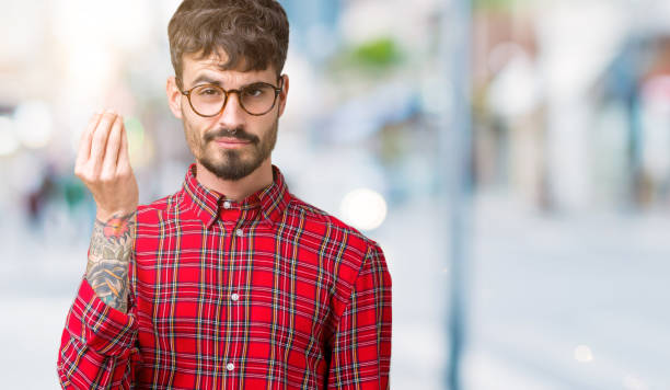 istock Young handsome man wearing glasses over isolated background Doing Italian gesture with hand and fingers confident expression 1098437510