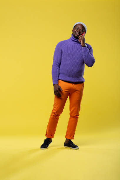 istock Cheerful brunette man demonstrating colorful stylish clothes 1098439366