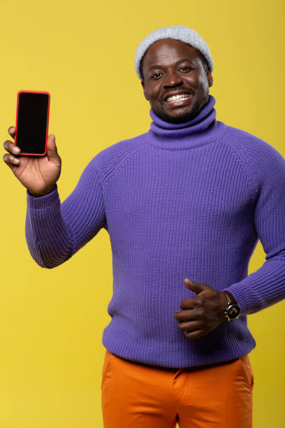 istock Handsome young man showing his new gadget 1098439374