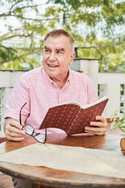 istock Positive senior man with book 1098439790