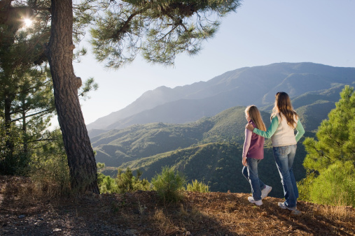 Mother and daughters hiking in the mountains. Nature and active lifestyle themes.