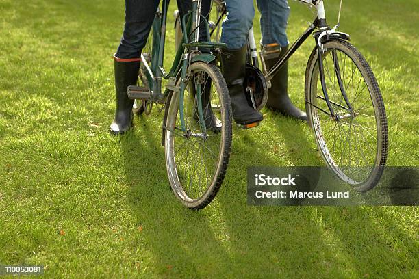 Closeup Two People Old Bicycles Grass Stock Photo - Download Image Now - 30-34 Years, 30-39 Years, Adult