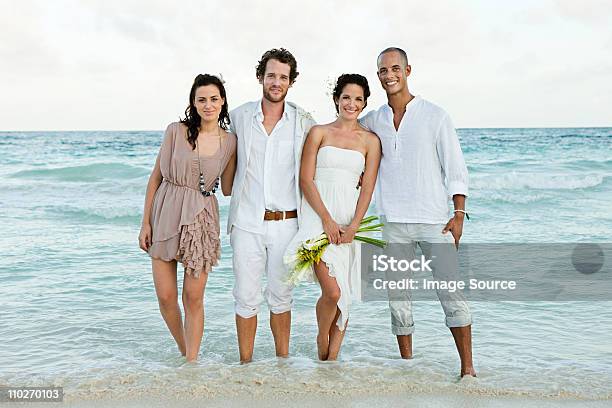 Married Couple And Friends Paddling In Sea 결혼식에 대한 스톡 사진 및 기타 이미지 - 결혼식, 해변, Destination Wedding