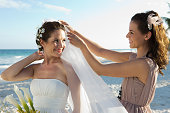Bridesmaid adjusting bride's veil