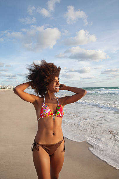 istock Happy sensuous woman standing on the beach 110829011