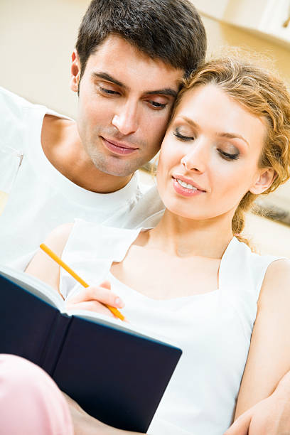 istock Young couple with notebook or organizer at home 110845144