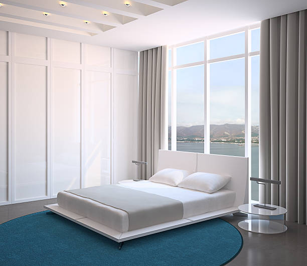 istock Modern bedroom with blue rug, large bed, and view 110864994