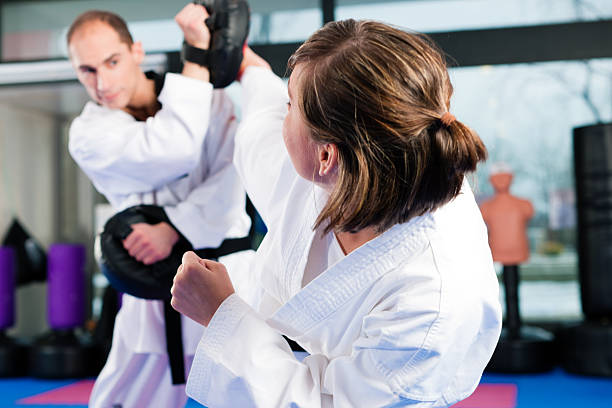 istock A man and a woman, both black belts, sparing in martial arts 110875968