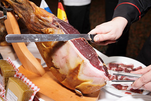 Waiter is slicing jamon