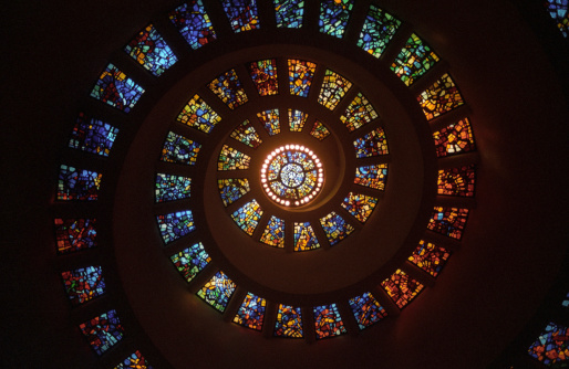 Spiral stained glass window ceiling from inside the prayer chapel of Thanksgiving Square in downtown Dallas, Texas.