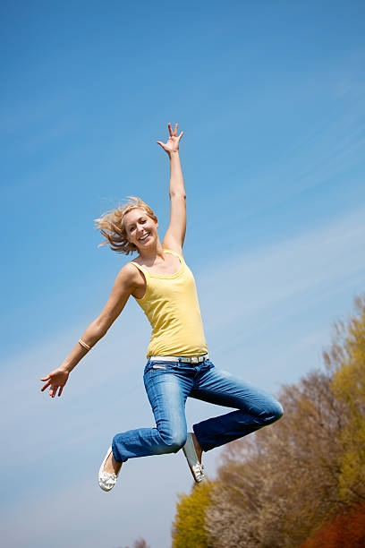 istock Active young woman jumping high in sunshine 110900887