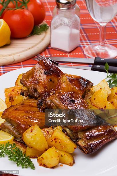 Grilled Ribs With Baked Potato Stock Photo - Download Image Now - Baked, Baked Potato, Barbecue - Meal