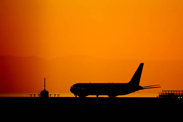 airplane at sunset stock photo