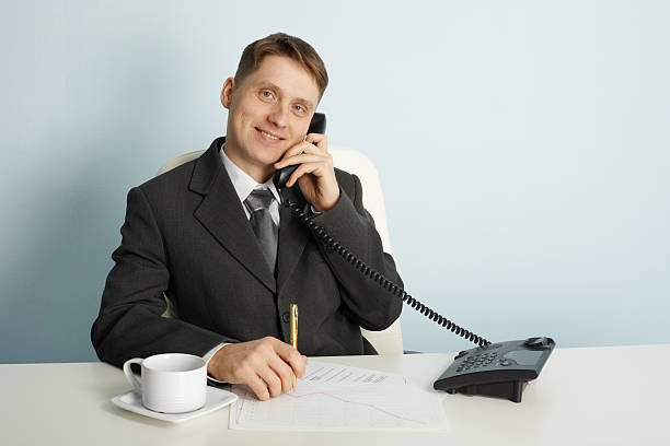 istock Smiling businessman in talks on phone 110916219