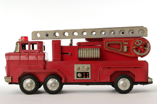 Rare vintage fire toy truck isolated on white background.