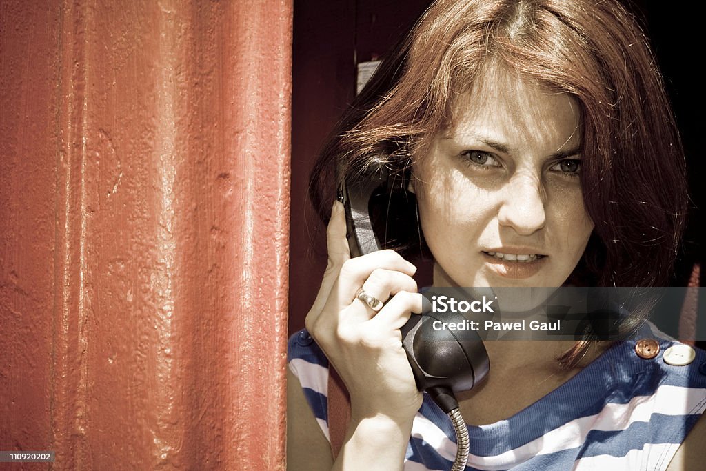 Young woman in telephone booth A girl talks on the phone. 20-24 Years Stock Photo