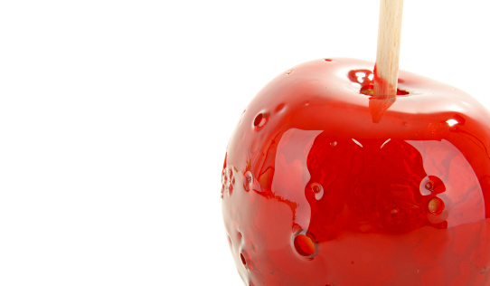 A close-up shot of half an apple being dropped into water.