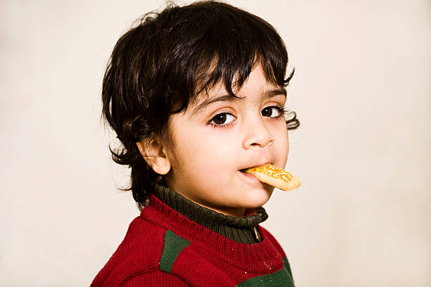 little boy eating cookies. stock photo