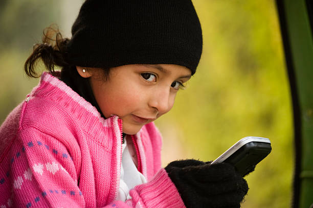 little girl messaging on the cell phone. stock photo