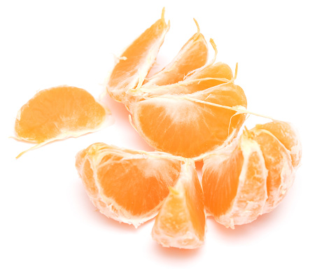 Penang, Malaysia\n\nClose up of mandarin oranges that I have peeled open. And then placed in a heap, on a white plate. Copy space available