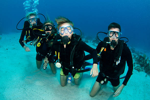Family of scuba divers scuba diving family stock pictures, royalty-free photos & images