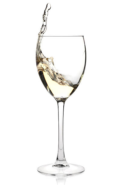 istock White wine splashing in a glass on white background 110950209
