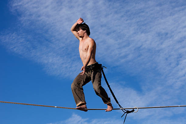 Young Man on a High Slackline stock photo