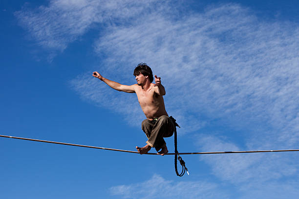 istock Young Man Crossing Legs on a Slackline 110954306